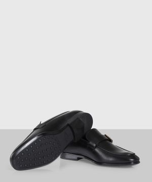 Black leather loafers with metal detail