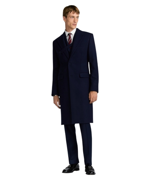Coat with buttoned strap